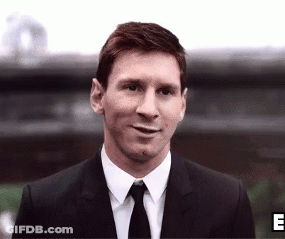 Smiling Man In Suit And Tie Outside Building GIF
