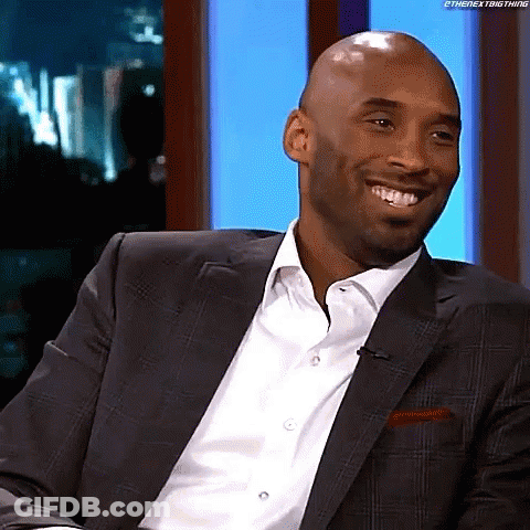 Smiling Man In Suit Looking At Camera GIF