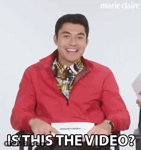 Smiling Man Red Jacket Asks Is This Video GIF