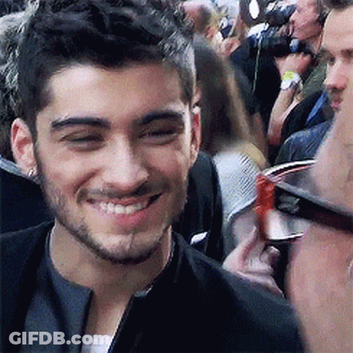 Smiling Man With Beard And Glasses In Front Of Crowd GIF