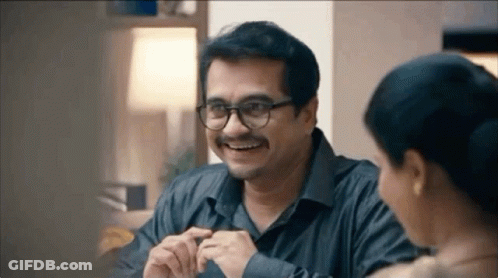 Smiling Man With Glasses And Mustache Talking To Woman GIF