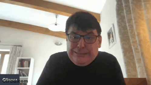 Smiling Man With Glasses At Glinner Sign GIF