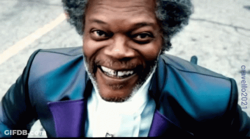 Smiling Man With Gray Hair In Blue And Purple Suit GIF