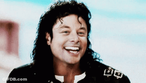 Smiling Man With Long Hair Black Jacket White Collar GIF