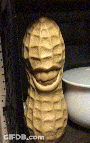 Smiling Peanut Statue On Shelf GIF