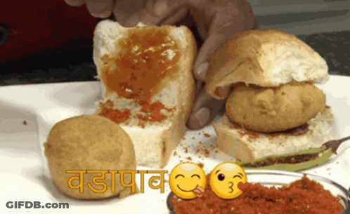 Smiling Person Holding Sandwich With Sauce GIF