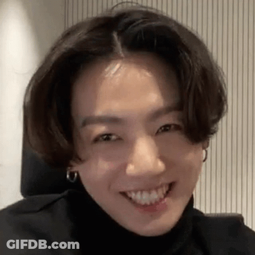 Smiling Person With Turtleneck And Earrings GIF