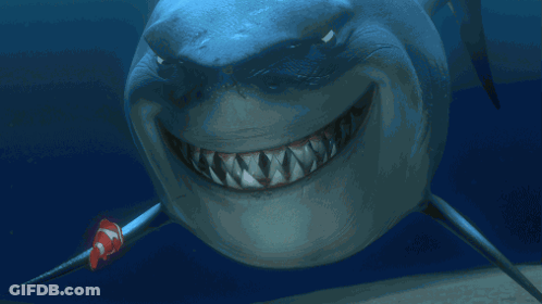 Smiling Shark With Clown Fish Behind GIF