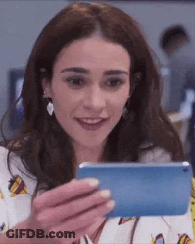 Smiling Woman Holding Cell Phone GIF