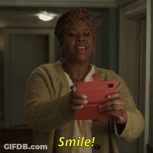 Smiling Woman Holding Cell Phone Saying Smile GIF