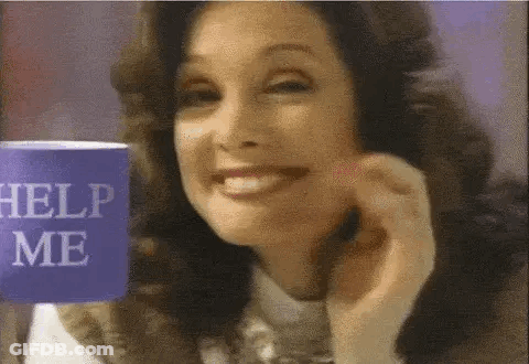 Smiling Woman Holding Help Me Cup GIF