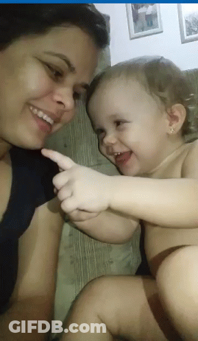 Smiling Woman Holding Pointing Baby GIF