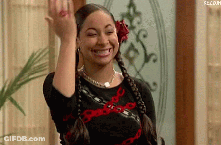 Smiling Woman In Black Dress With Red Flower Waving GIF