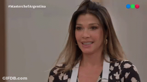Smiling Woman In Black-White Floral Shirt And Apron GIF