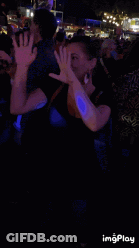 Smiling Woman In Front Of Crowd GIF