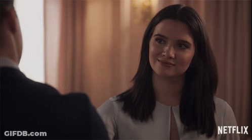 Smiling Woman Looking At Man With Netflix Logo GIF