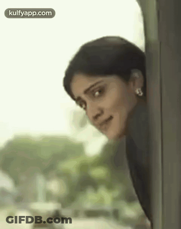 Smiling Woman Peeking From Train Window GIF