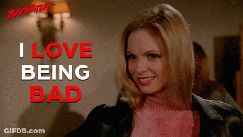 Smiling Woman Pink Sweater I Love Being Bad Sign GIF