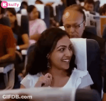 Smiling Woman Sitting On Airplane GIF