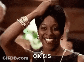 Smiling Woman Touching Hair With Necklace And Bracelets GIF