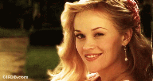 Smiling Woman With Flower In Hair GIF