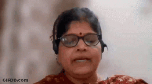 Smiling Woman With Glasses And Headphones GIF