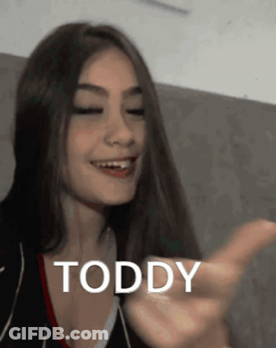 Smiling Woman With Long Hair Pointing Toddy GIF