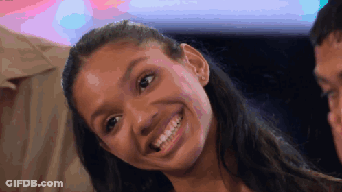 Smiling Woman With Ponytail And Colorful Background GIF