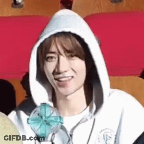 Smiling Young Man In Hoodie Holding Fan GIF