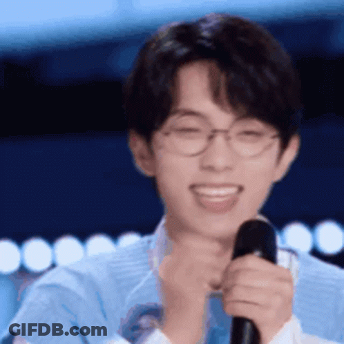 Smiling Young Man With Glasses And Microphone GIF