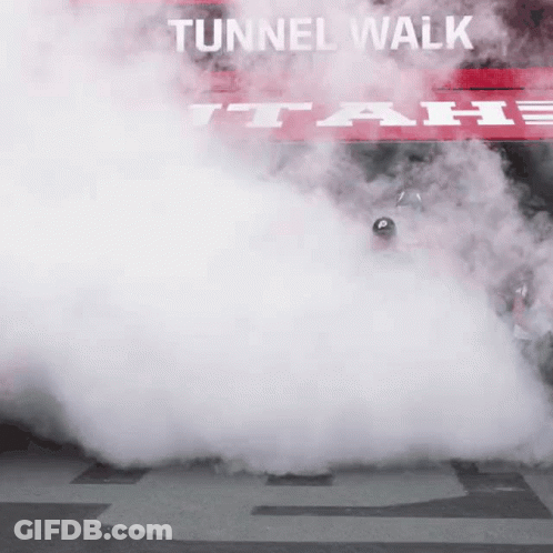 Smoke Coming Out Of A Car With A Sign That Says Tunnel Walk GIF