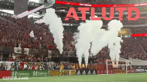 Smoke Coming Out Of A Soccer Field That Says Atl Uto GIF