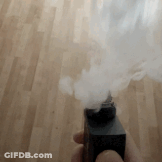 Smoke Is Coming Out Of A Black Object On A Wood Floor GIF