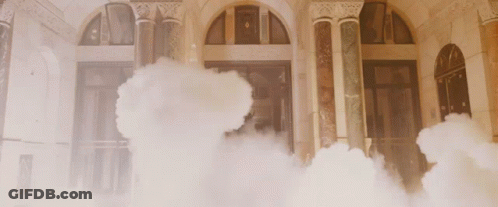 Smoke Is Coming Out Of A Building With Arched Windows GIF