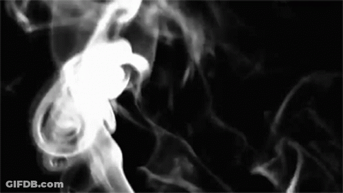 Smoke Is Coming Out Of A Pipe On A Black Background In A Black And White Photo . GIF