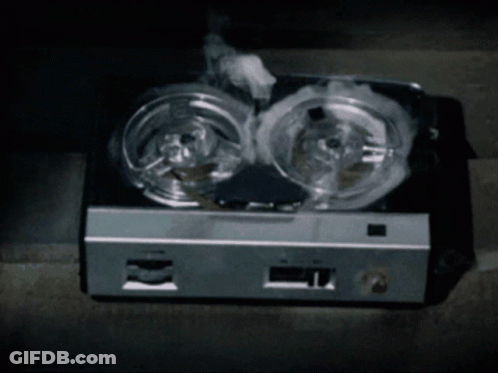Smoke Is Coming Out Of A Tape Recorder That Is Sitting On The Floor GIF