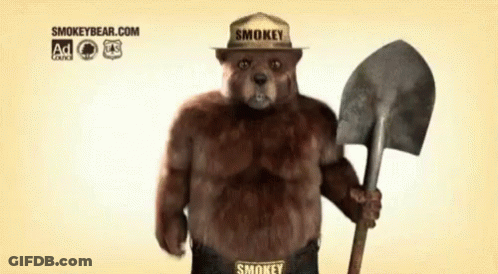 Smokey Bear Holding A Shovel And Wearing A Smokey Hat GIF