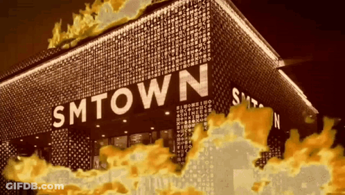 Smtown Is Written On The Side Of A Building With Flames Coming Out Of It GIF