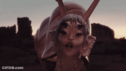 Snail Statue With Girl Face And Ears GIF