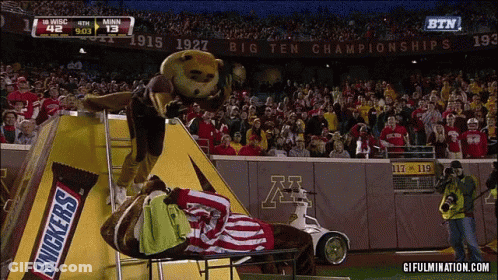 Snickers Bar Mascot On Football Field GIF