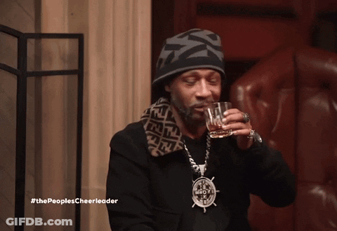 Snoop Dogg Drinking A Glass Of Whiskey With The Peoples Cheerleader Written Below Him GIF