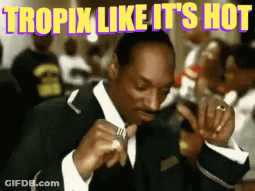 Snoop Dogg Eating With Fork Looking At Cell Phone GIF