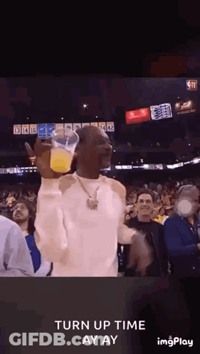 Snoop Dogg Holding Orange Juice In Crowd GIF