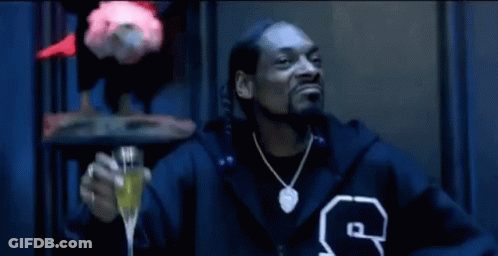 Snoop Dogg In Fur Coat Sitting In Chair GIF