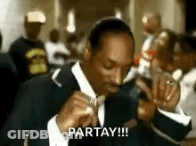 Snoop Dogg In Suit Smoking Cigarette In Crowd GIF