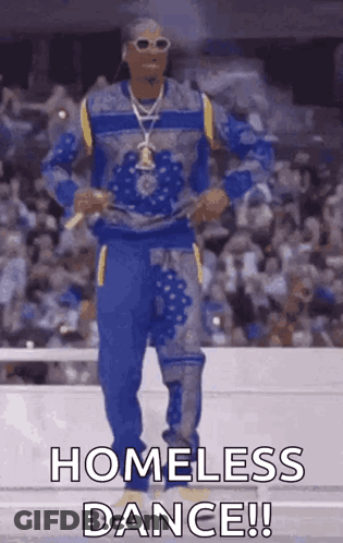 Snoop Dogg Is Dancing In Front Of A Crowd While Wearing A Blue And Yellow Outfit . GIF