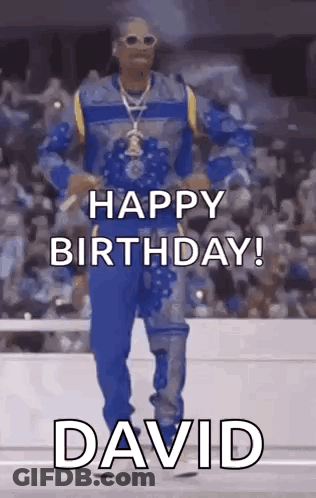 Snoop Dogg Is Dancing In Front Of A Crowd While Wearing A Blue And Yellow Outfit . GIF
