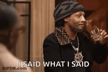 Snoop Dogg Is Holding A Glass Of Whiskey And Talking To A Woman . GIF