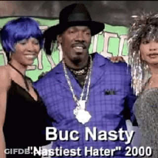 Snoop Dogg Is Posing For A Picture With Two Women While Wearing A Hat And A Necklace . GIF