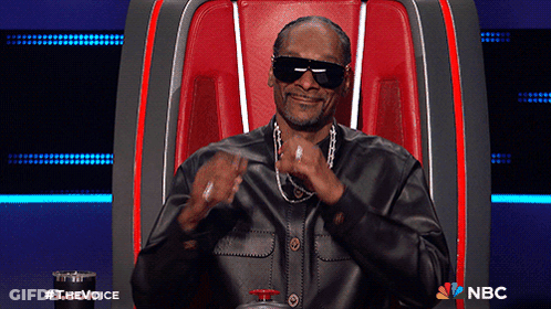 Snoop Dogg Is Sitting In A Chair With A Nbc Logo On The Bottom Right GIF